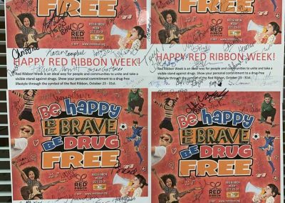 Red ribbon week flyers covered in signatures