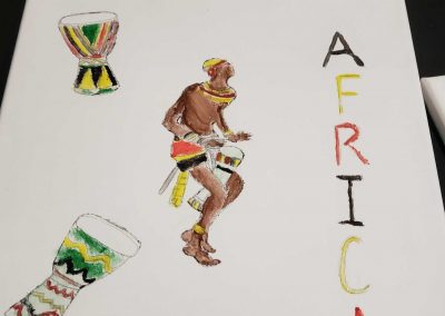 A painting of an African man playing a djembe drum. To other djembe drums are painted in the top left and bottom left corners. "Africa" is written down the right side.